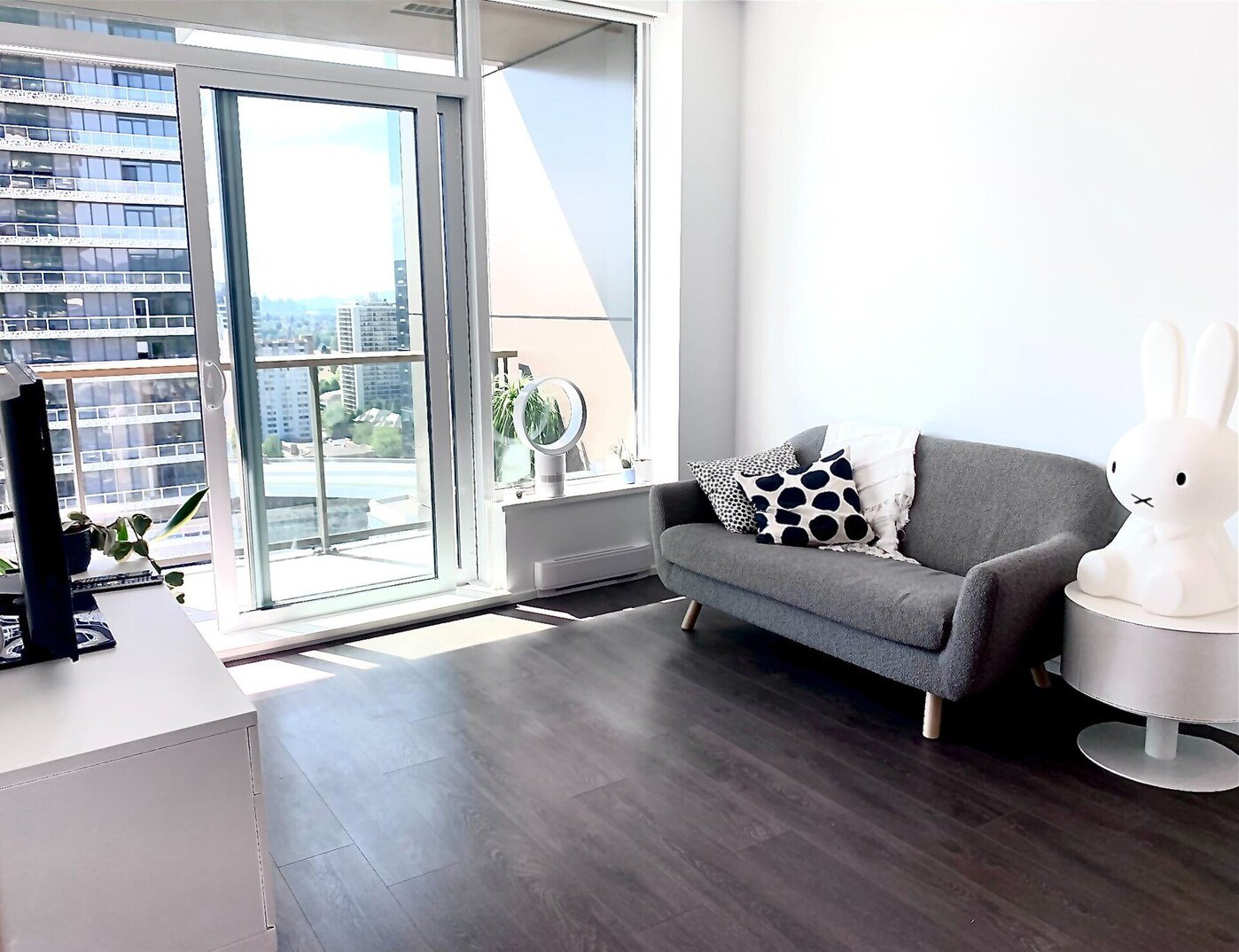 Living room with floor-to-ceiling windows and city views