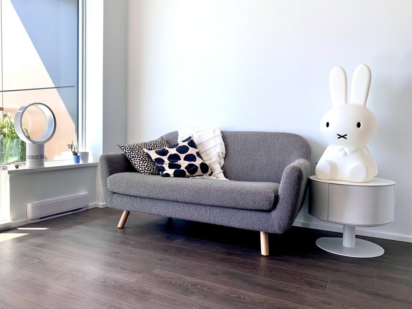 Living room with bouclé sofa and Miffy lamp
