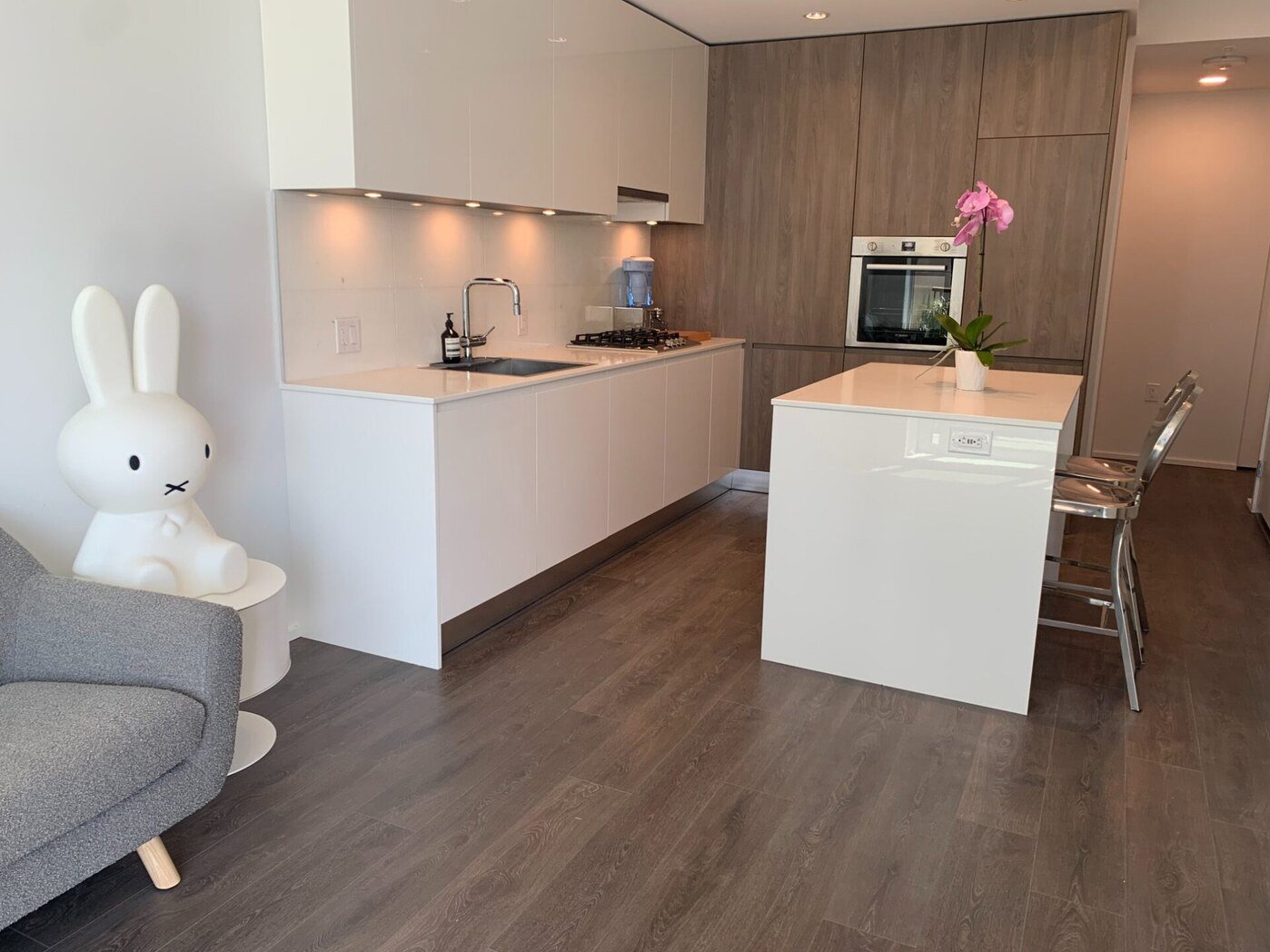 Kitchen with walnut cabinetry and island