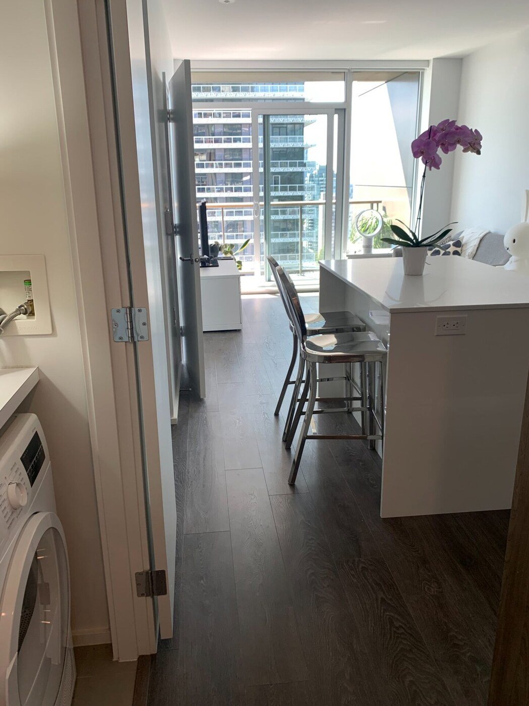 In-suite laundry with view to kitchen